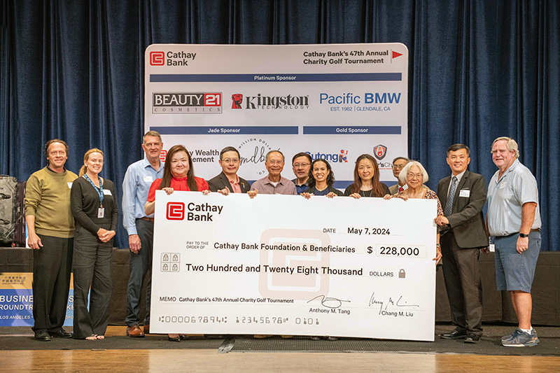 Cathay Bank presents a $228,000 check to representatives from local nonprofits who will benefit from the funds raised at the bank’s golf tournament event.